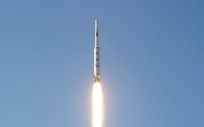 A picture taken from North Korean TV and released by South Korean news agency Yonhap showing North Korea's rocket launch of earth observation satellite Kwangmyongsong-4.