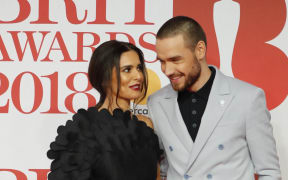 British singer-songwriter Liam Payne (right) and then-partner Cheryl pose on the red carpet on arrival for the BRIT Awards 2018 in London on 21 February, 2018.