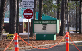 NEWPORT NEWS, VA - JANUARY 07: A school sign wishing students a "Happy New Year" is seen outside Richneck Elementary School on January 7, 2023 in Newport News, Virginia. A 6-year-old student was taken into custody after reportedly shooting a teacher during an altercation in a classroom at Richneck Elementary School on Friday. The teacher, a woman in her 30s, suffered “life-threatening” injuries and remains in critical condition, according to police reports.   Jay Paul/Getty Images/AFP (Photo by Jay Paul / GETTY IMAGES NORTH AMERICA / Getty Images via AFP)