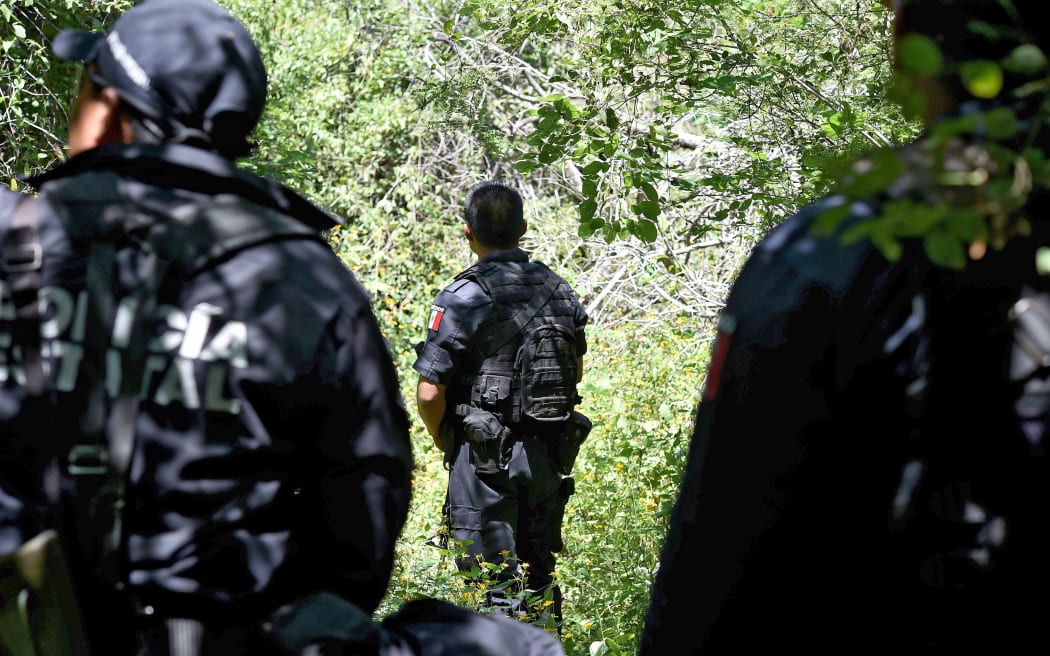 State police guard a mass grave that was found earlier this month near Iguala in Guerrero state.