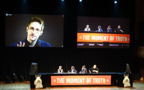 Edward Snowden talking via video link at the meeting.