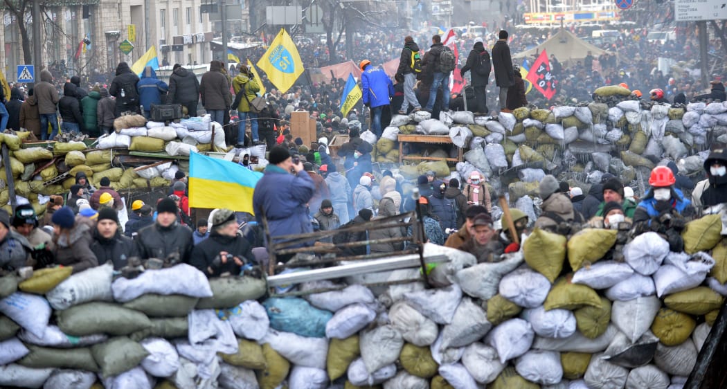 Anti-government protesters gather at a road block in central Kiev on Sunday.