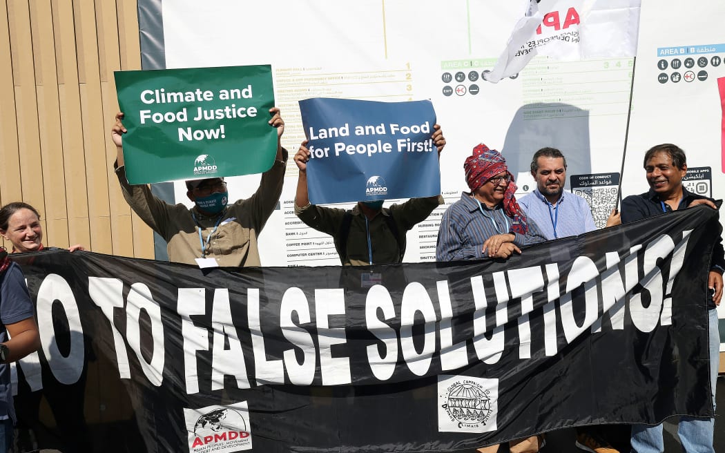 Climate activists from the Asian People's Movement on Debt and Development (APMDD) protest at the Sharm el-Sheikh International Convention Centre, in Egypt's Red Sea resort city of the same name, during the COP27 climate conference today.