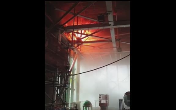 A screenshot from a video showing the battle against the fire from inside the building.