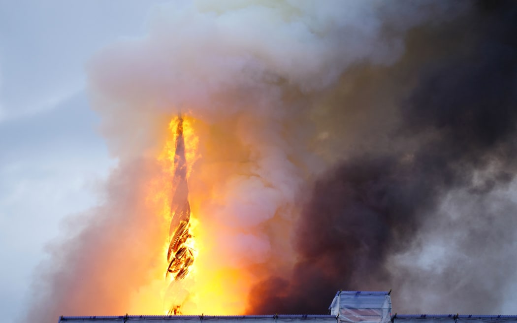 This photograph shows flames engulfing the Copenhagen's Stock Exchange building, in Copenhagen, on April 16, 2024. (Photo by Ida Marie Odgaard / Ritzau Scanpix / AFP) / Denmark OUT