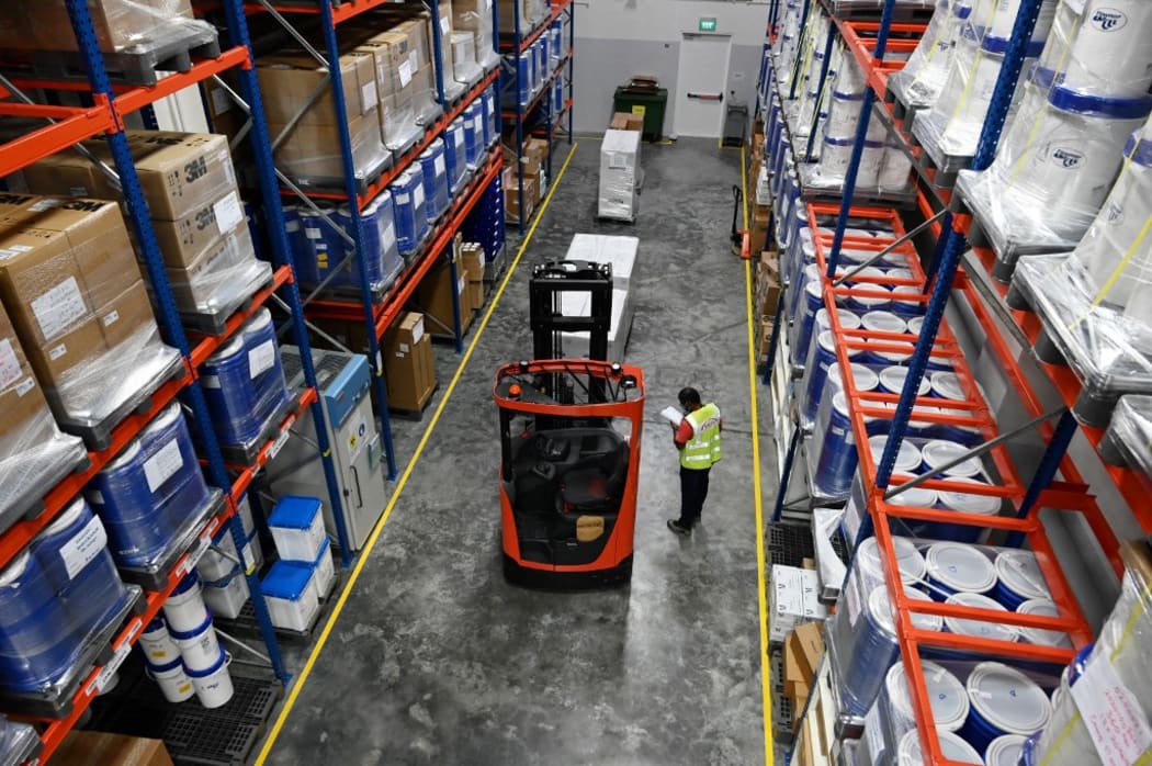 This photograph taken on November 24, 2020 shows a warehouse technician working at Takeda Pharmaceuticals (Asia Pacific) in Singapore.