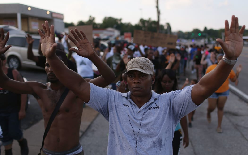 People protesting the death of Michael Brown chanted: "Hands up, don't shoot" during a demonstration in Ferguson yesterday.