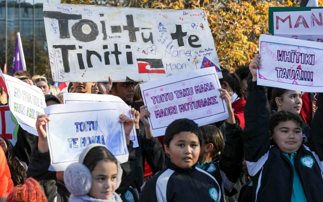 Protestors gather near the Bridge of Remembrance in Christchurch