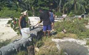 Youths on South Tarawa rebuilding seawalls at low tide, 30 August 2019