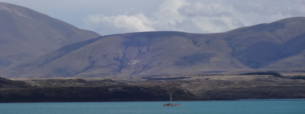 The barge at anchor at the first drill site in Lake Ohau.