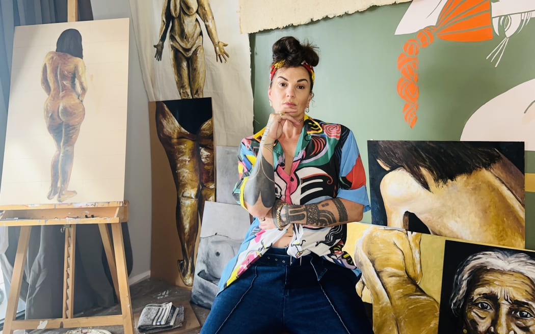 Hollie Smith in the studio with her artworks.