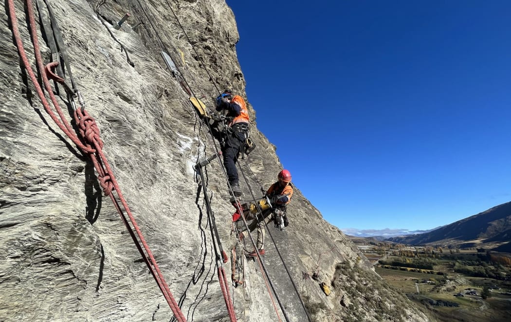 Geotech abseilers at work on Yates Feature, on the Nevis Bluff