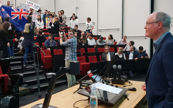 Don Brash grins at protestors.