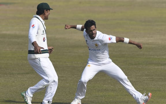 Pakistan's Hasan Ali (R) celebrates after taking five wickets during the fifth and final day of the second Test cricket match against South Africa at the Rawalpindi Cricket Stadium in Rawalpindi on February 8, 2021.