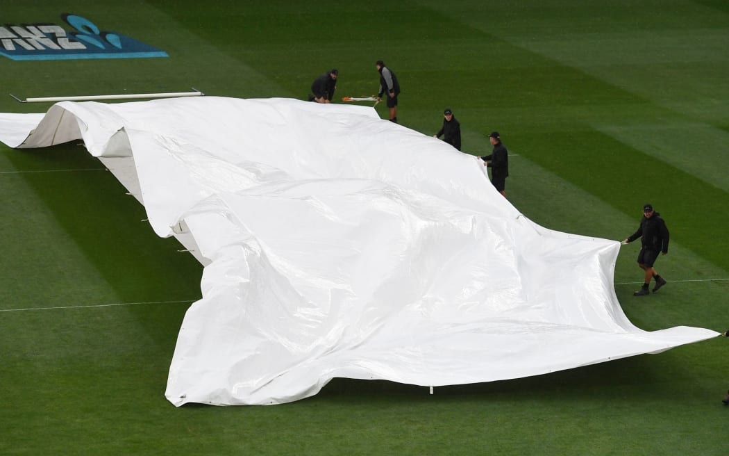The covers over the wicket as the rain arrives.