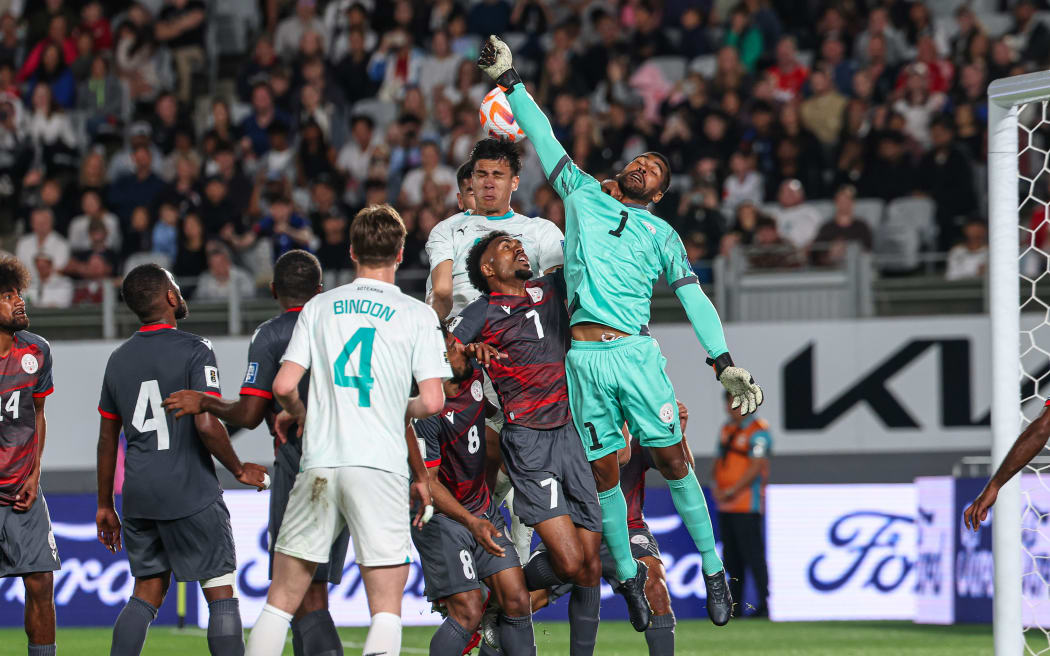 New Zealand's Michael Boxall scores for New Zealand against New Caledonia goalkeeper Rocky Nyikeine.
