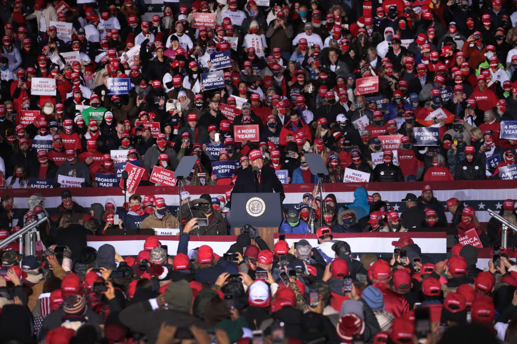Supporters listen to Donald Trump speak at the Kenosha Regional Airport on 2 November.