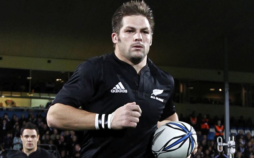 Richie McCaw leads the All Blacks out onto the field before a match in 2010.