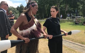 Prime Minister Jacinda Ardern takes instruction for paddling in preparation for boarding a waka hourua at Waitangi.