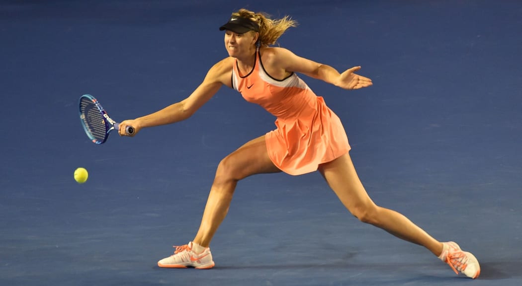 Russia's Maria Sharapova returns against Switzerland's Belinda Bencic on day seven of the 2016 Australian Open in Melbourne, January 24, 2016. AFP PHOTO / PAUL CROCK