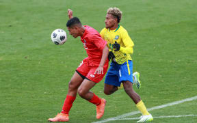 Tonga’s Sosefo Tolu and Solomon Island’s Dalton Saeni (right) battle for the ball.