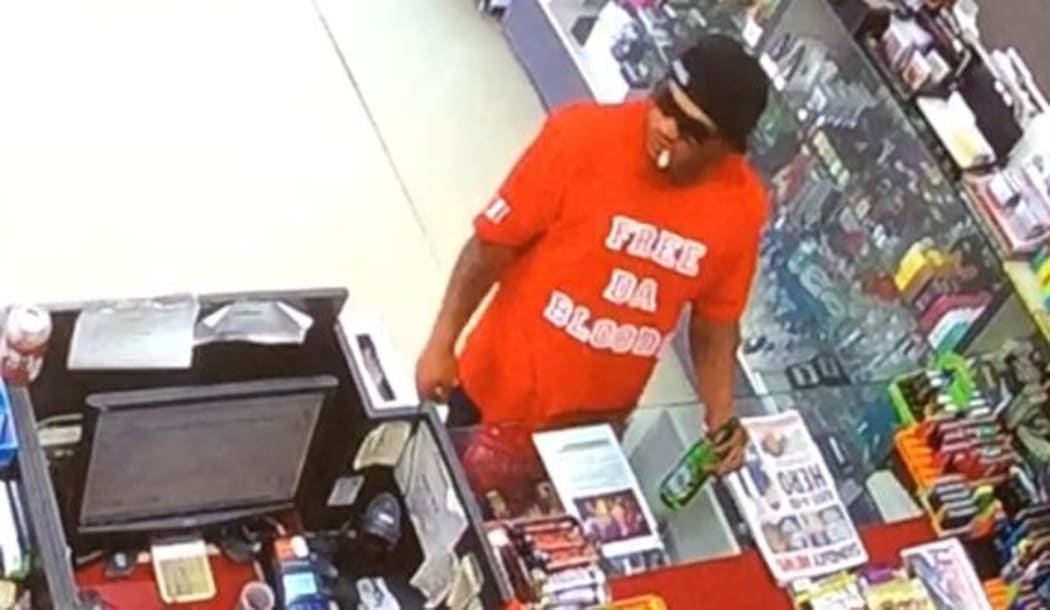 The attacker, as pictured, was wearing a red t-shirt and black jeans with a red bandana tucked in to the waistline.