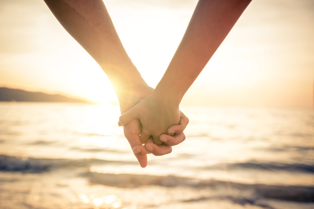 Couple holding hands.