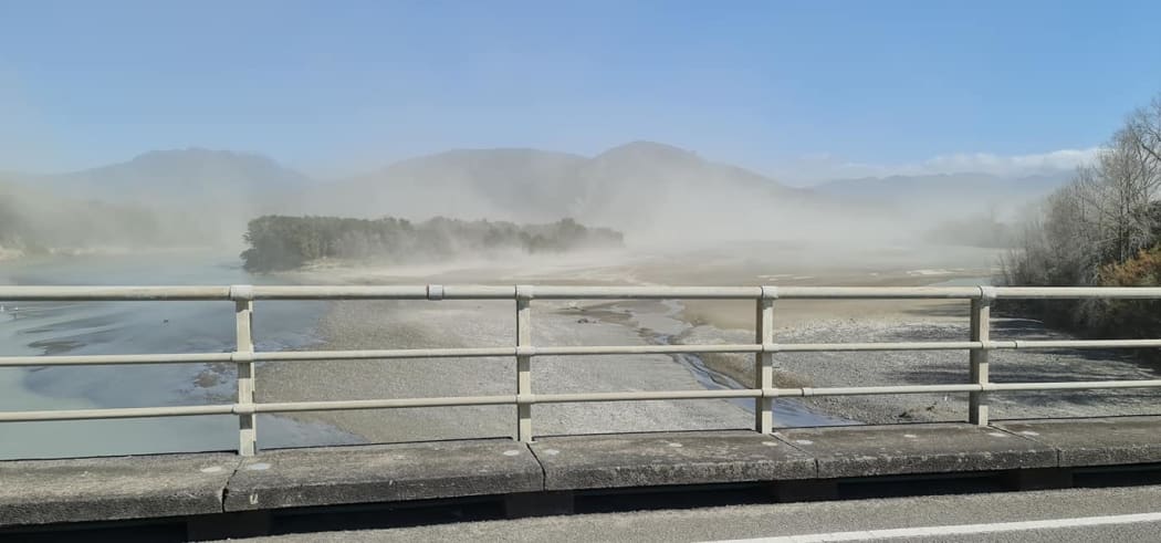 Clouds of dust rise off the Waiapu River and surrounds.