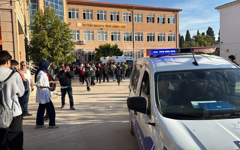 This handout photograph taken and released on September 22,2026 by Turkish news agency DHA (Demiroren News Agency) shows ambulances and police officers waiting in front of a high school outside which a gunman opened fire wounding eight people, and was detained shortly afterwards, in Turgutlu, an area west of the resort city of Izmir. (Photo by Handout / DHA (Demiroren News Agency) / AFP) / Turkey OUT / RESTRICTED TO EDITORIAL USE - MANDATORY CREDIT "AFP PHOTO / DHA (Demiroren News Agency) " - NO MARKETING NO ADVERTISING CAMPAIGNS - DISTRIBUTED AS A SERVICE TO CLIENTS
