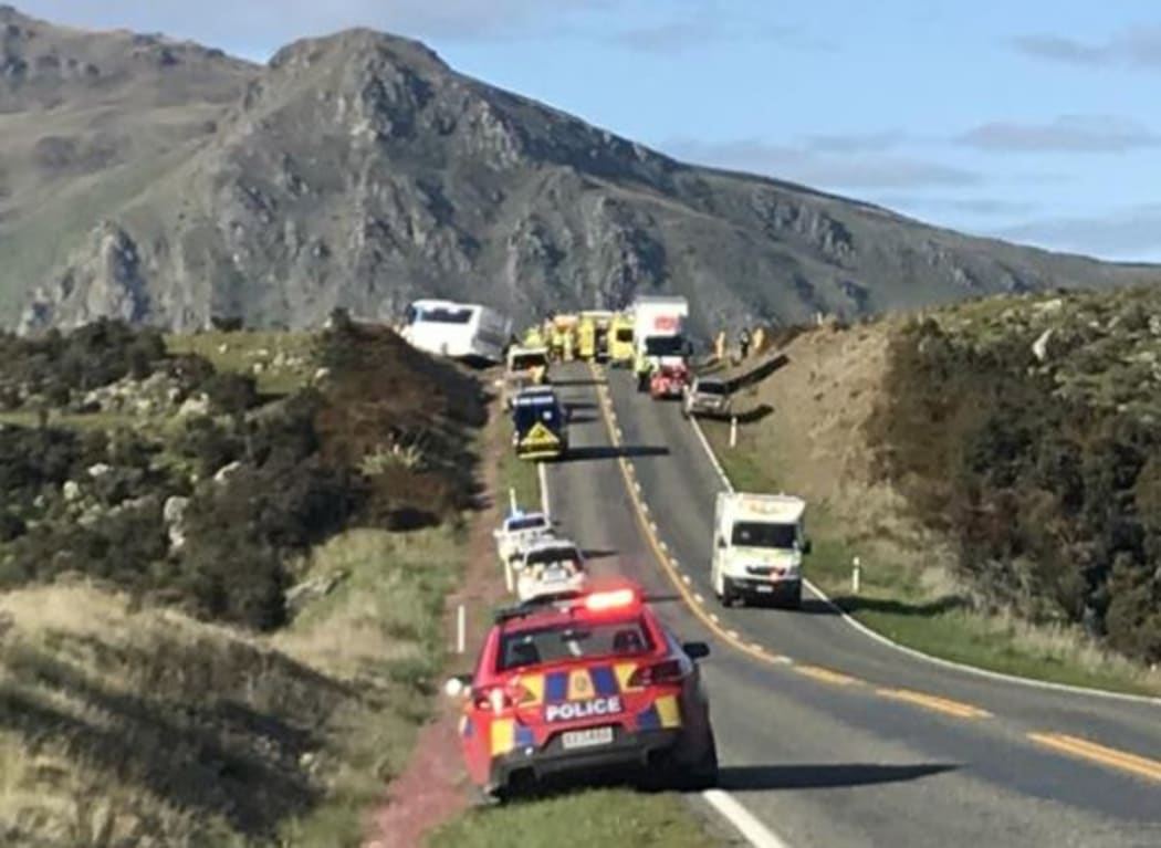 One person is dead and nine injured after a crash between a car and bus south of Kingston this morning.
