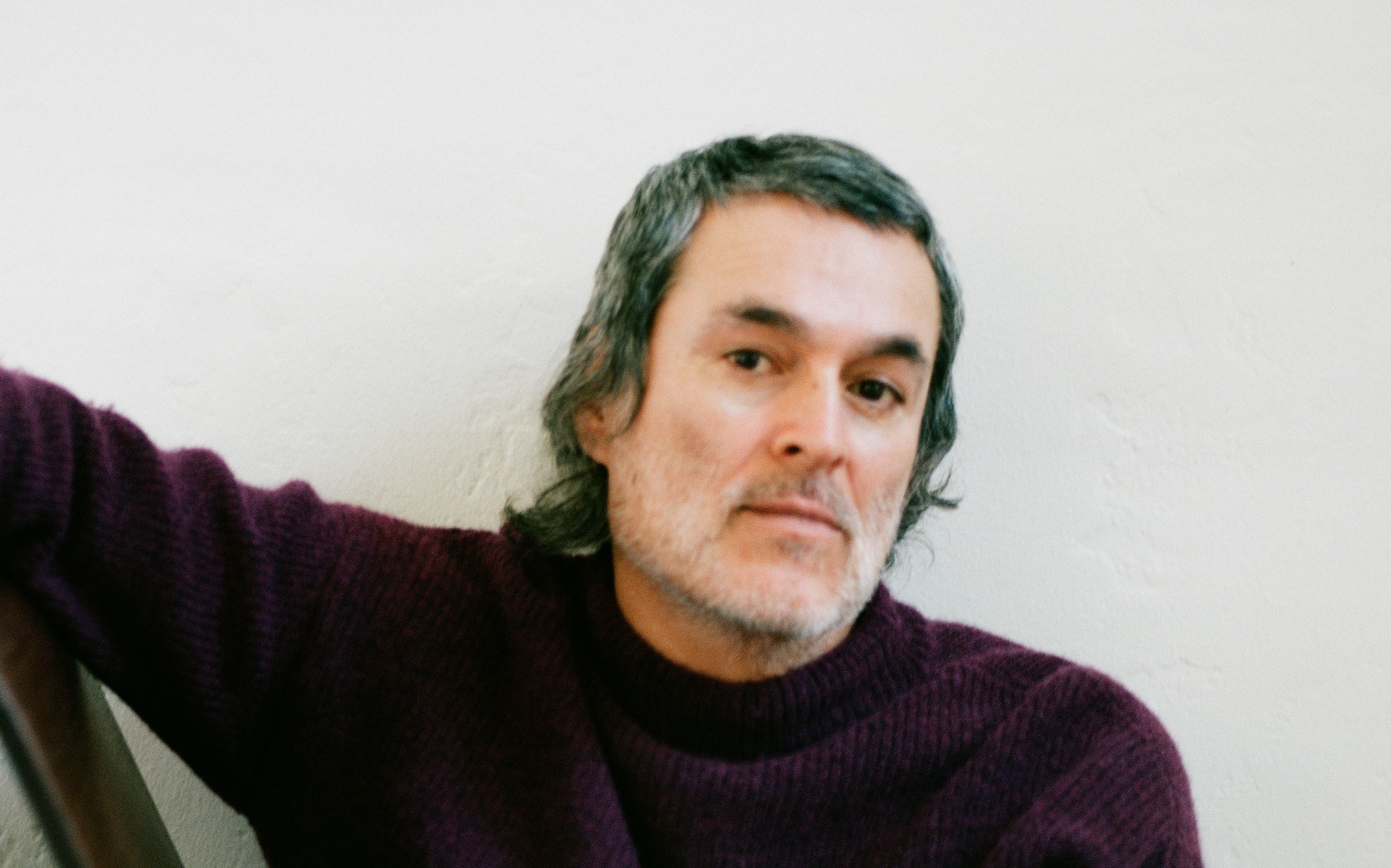 Man in a woolly jersey looking at the camera