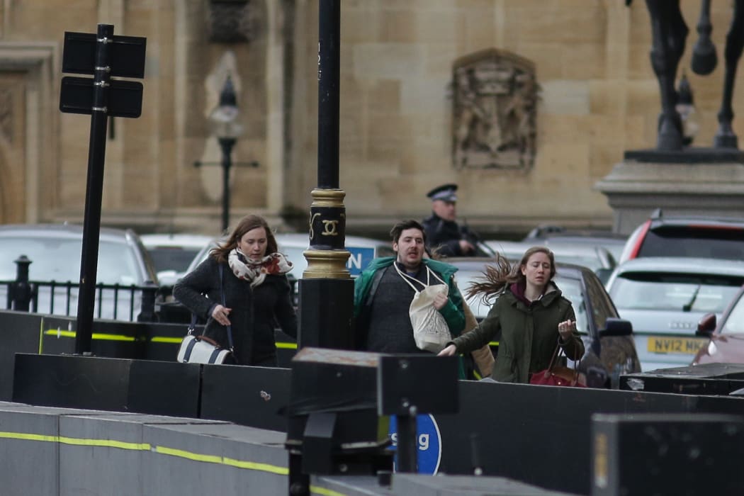 People run from the scene outside the Houses of Parliament.