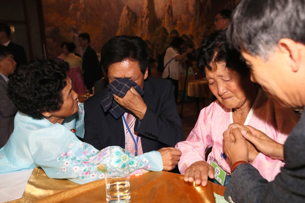 South Korean Kim Choon-sik (2nd L), 80, meets his North Korean sister Kim Choon-sil (L), 77.