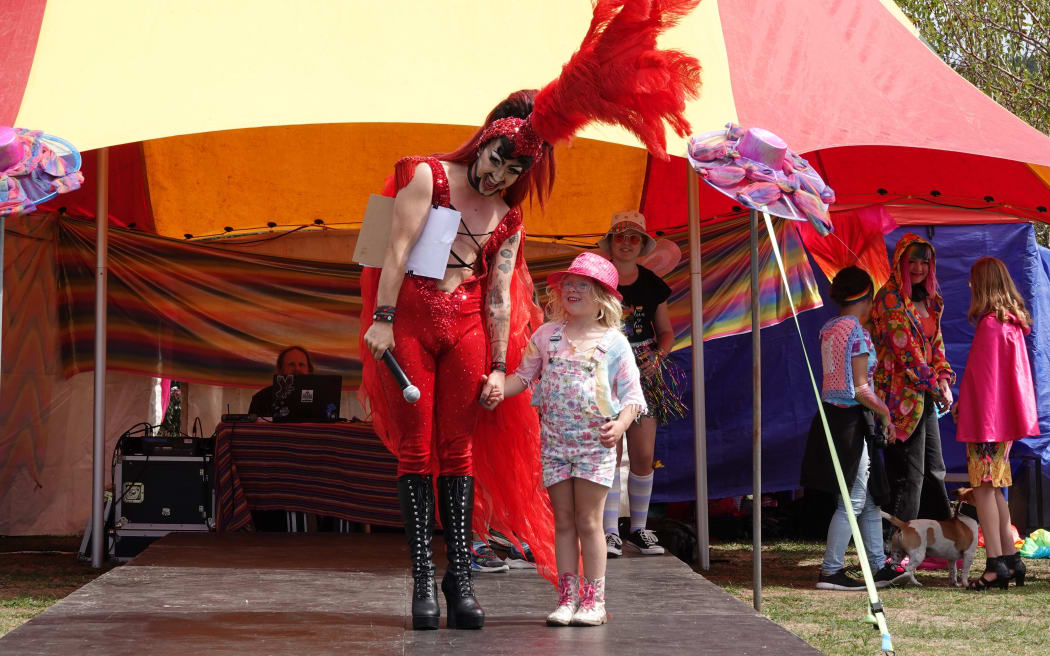 MC Hugo Grrrl accompanies five-year-old Moana onto the catwalk.