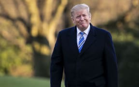 United States President Donald Trump walks on the South Lawn of the White House.
