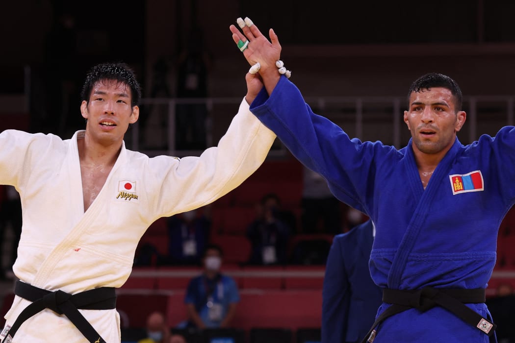 Gold medallist Japan's Takanori Nagase and silver medallist Mongolia's Saeid Mollaei react after the judo men's -81kg gold medal bout.