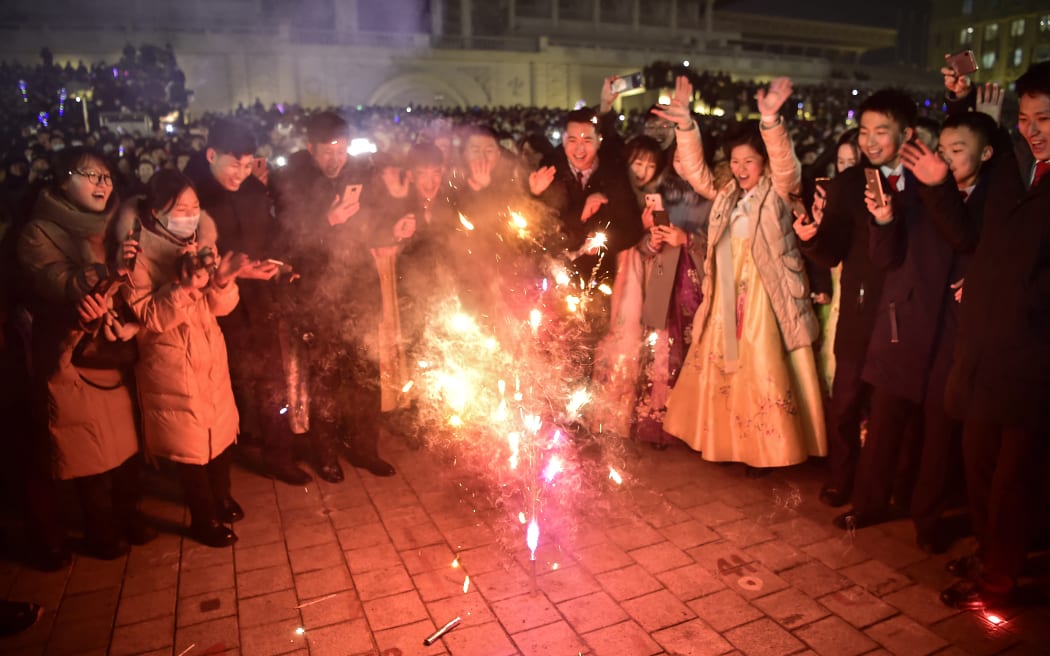 People take part in celebrations to welcome in the new year at Kim Il Sung Square in Pyongyang on 1 January.