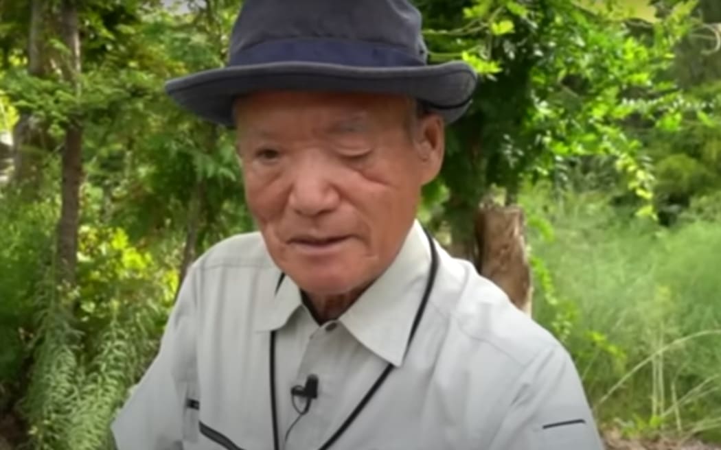 Katsuo Harada was badly attacked by a bear 24 years ago, now he is director of the Farming Support organisation in Hokkaido. He is shown in a still from a video by Japan's public media organisation NHK.