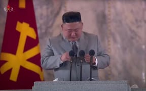 North Korean leader Kim Jong Un, as seen from a KCTV broadcast on October 10, 2020, pausing as he makes a speech prior to a military parade on Kim Il Sung square in Pyongyang.