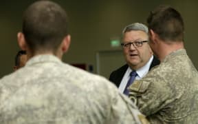 Troops returning from Iraq are welcomed by Defence Minister Gerry Brownlee at Ohakea Air Base on 16 November 2015.