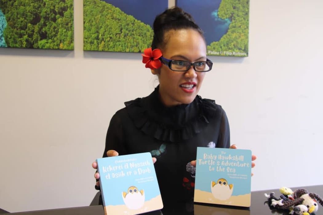 Palau's ambassador to the United Nations Olai Uludong with copies of the children's book by Toni Soalablai.