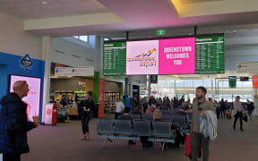 Travellers arrive at Queenstown Airport.