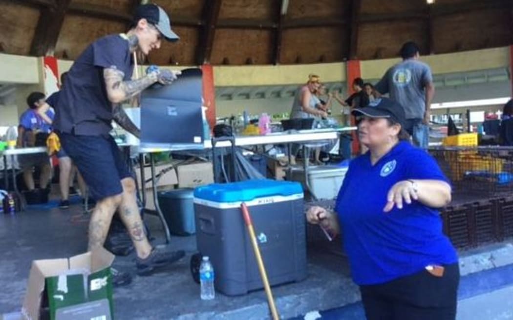 Animal Balance's Meredith Hippert talking with President of Alofa mo Meaola, Mona King at the first day of clinics