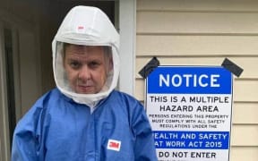 Patrick Gower dons a hazmat suit during the making of his new documentary, Patrick Gower: On P.