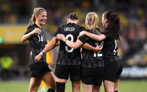 Anna Green (centre) of New Zealand celebrates scoring a goal against Australia 2022.