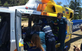 Paramedics treat the 31-year-old man who was attacked by a shark while spearfishing off Yeppoon in central Queensland.