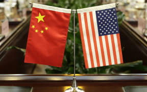 (FILES) In this file photo taken on June 30, 2017, flags of the US and China are placed ahead of a meeting at the Ministry of Agriculture in Beijing.