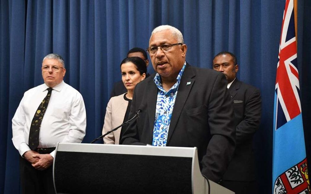 Fiji's prime minister Frank Bainimarama, flanked by government officials and ministers, announces the country's first case of Covid-19 coronavirus on Thursday.