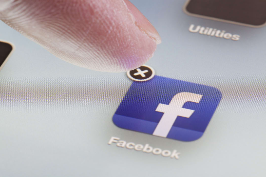 Adelaide, Australia - October 3, 2012: Deleting the Facebook app from an iPad by clicking the cross at the corner of the icon for the app.