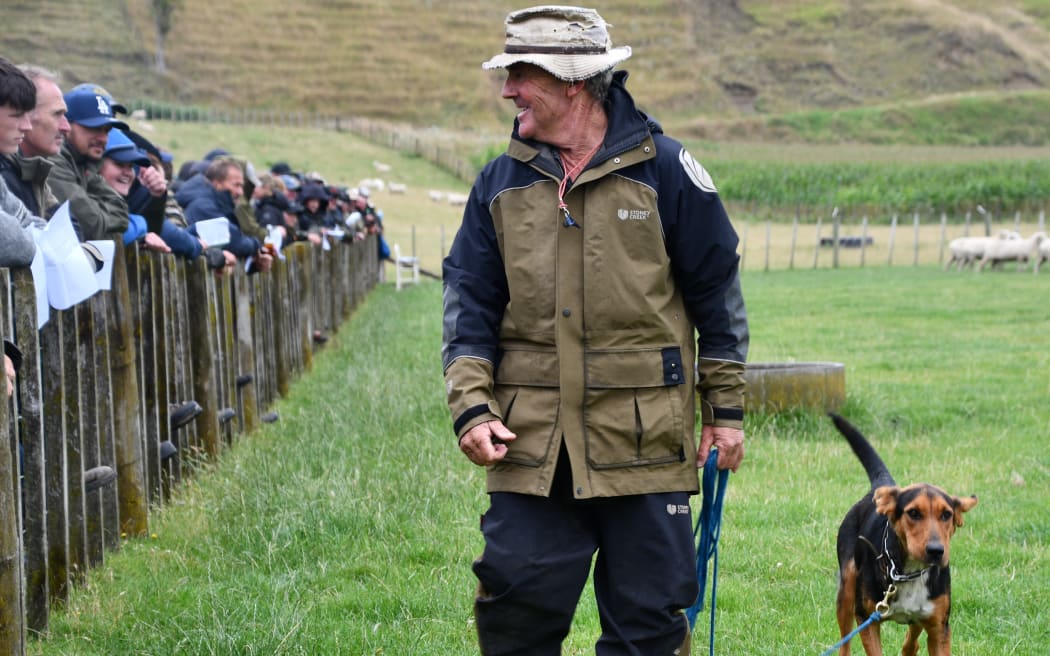 Jonathan Smailes shows his 11-month-old Wedge to the crowd at the Parapara-Makirikiri Sheep Dog Trial Club auction. She sold for $9800.
